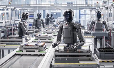 Humanoid robots working on an automated factory assembly line using AI and robotics technology