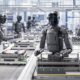 Humanoid robots working on an automated factory assembly line using AI and robotics technology