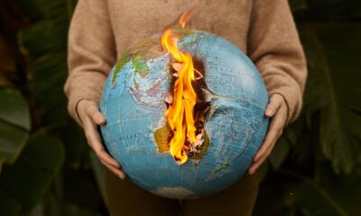 Burning globe held in hands symbolizing global warming and climate crisis