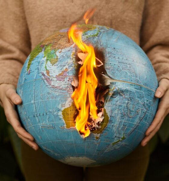 Burning globe held in hands symbolizing global warming and climate crisis