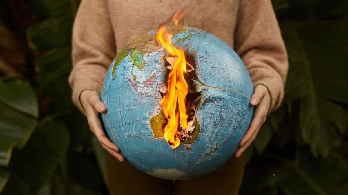Burning globe held in hands symbolizing global warming and climate crisis