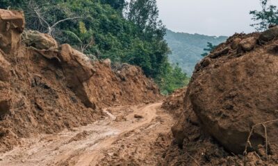 Mud and large boulders block a road after the Wayanad landslide near Kalladi in Meppadi
