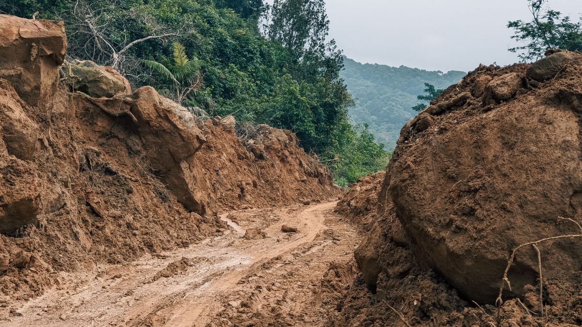 Mud and large boulders block a road after the Wayanad landslide near Kalladi in Meppadi
