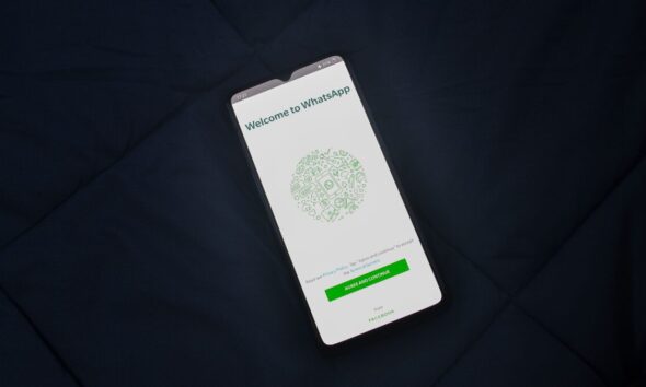A smartphone displaying the WhatsApp welcome screen, representing India's scrutiny of the messaging platform's proposed username feature over fraud concerns.
