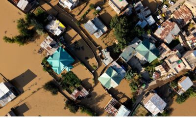 Aerial view of floodwaters inundating homes and roads after heavy rainfall, representing the impact of flash floods in Jammu and Kashmir.