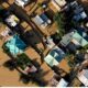 Aerial view of floodwaters inundating homes and roads after heavy rainfall, representing the impact of flash floods in Jammu and Kashmir.