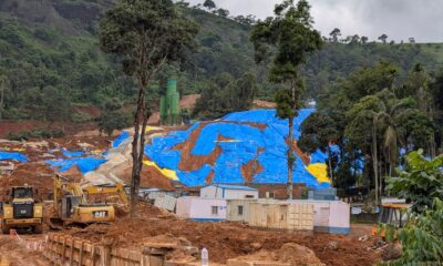 Excavated soil covered with blue tarpaulin at the Anakkampoyil–Kalladi tunnel construction site in Meppadi, Wayanad, where residents fear landslide risks during the monsoon.