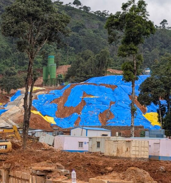 Excavated soil covered with blue tarpaulin at the Anakkampoyil–Kalladi tunnel construction site in Meppadi, Wayanad, where residents fear landslide risks during the monsoon.