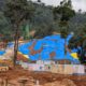 Excavated soil covered with blue tarpaulin at the Anakkampoyil–Kalladi tunnel construction site in Meppadi, Wayanad, where residents fear landslide risks during the monsoon.