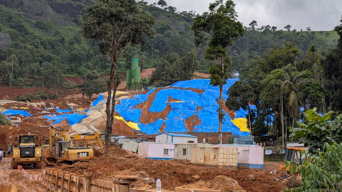 Excavated soil covered with blue tarpaulin at the Anakkampoyil–Kalladi tunnel construction site in Meppadi, Wayanad, where residents fear landslide risks during the monsoon.