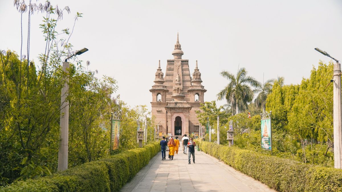 Visitors walk towards the Mulagandha Kuti Vihara Temple in Sarnath, Uttar Pradesh, recently inscribed as India's 45th UNESCO World Heritage Site.
