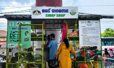 People browse donated clothes and household items at the Maradu Nagarasabha Swap Shop, a community reuse centre promoting recycling and sustainable consumption in Kerala.