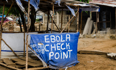 An Ebola screening checkpoint at a roadside in an African community during an Ebola outbreak.