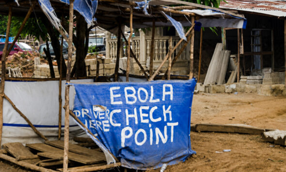 An Ebola screening checkpoint at a roadside in an African community during an Ebola outbreak.