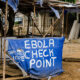 An Ebola screening checkpoint at a roadside in an African community during an Ebola outbreak.