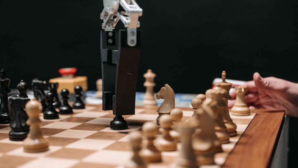 Our Algorithm Knows What We Want Before We Do. That is the Problem. 42 Alt text: AI-powered robotic arm playing chess against a human on a chessboard.