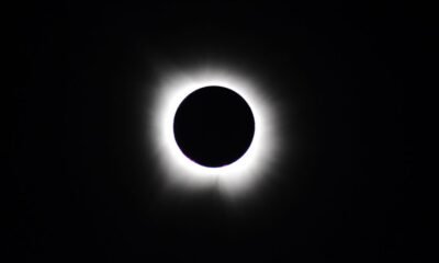 Total solar eclipse with the Moon completely covering the Sun, revealing the glowing solar corona