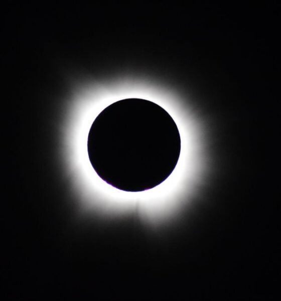 Total solar eclipse with the Moon completely covering the Sun, revealing the glowing solar corona