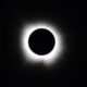 Total solar eclipse with the Moon completely covering the Sun, revealing the glowing solar corona