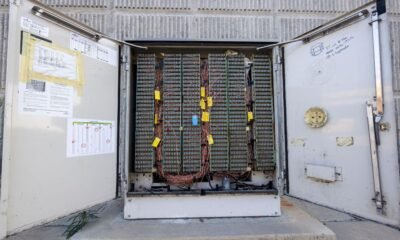 Open battery storage enclosure containing hundreds of connected battery cells and electrical wiring that may help store solar energy.
