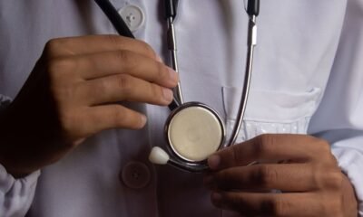 Health worker holding a stethoscope, illustrating risks faced by medical professionals during attacks on health care