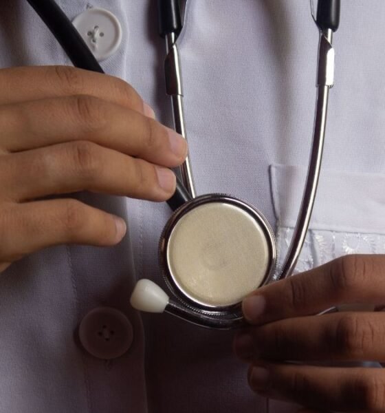 Health worker holding a stethoscope, illustrating risks faced by medical professionals during attacks on health care