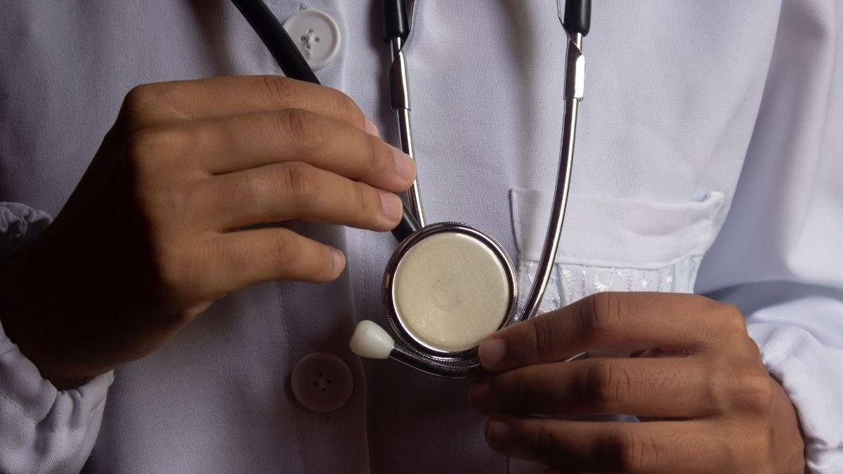 Health worker holding a stethoscope, illustrating risks faced by medical professionals during attacks on health care