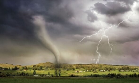 Tornado and lightning over a rural landscape, illustrating the threat of unprecedented extreme events.