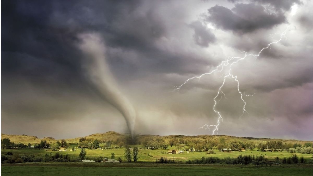 Tornado and lightning over a rural landscape, illustrating the threat of unprecedented extreme events.