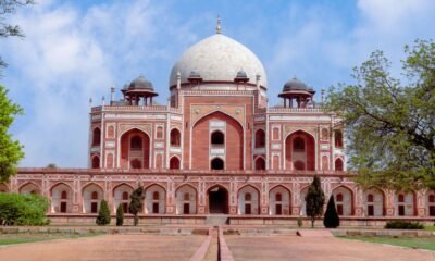 Humayun’s Tomb in Delhi surrounded by trees and gardens under a partly cloudy sky