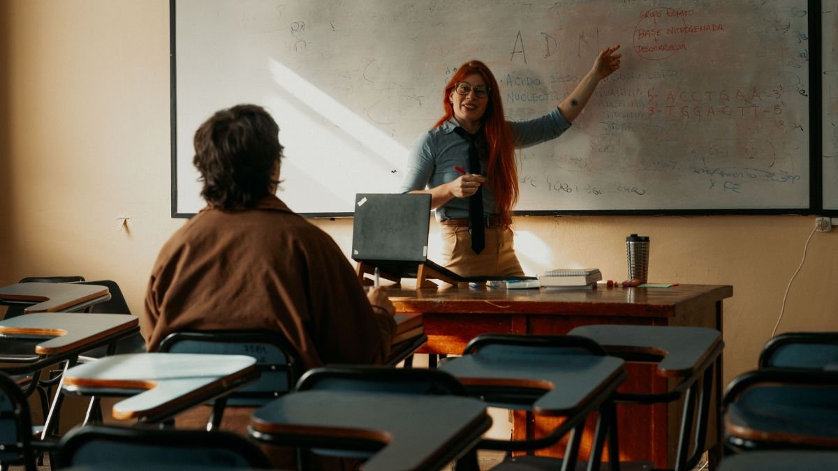 Teacher addressing students in a university classroom, representing the importance of studying at UGC-recognised institutions and avoiding fake universities in India.