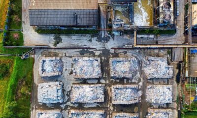 Aerial view of an industrial facility with piles of processed waste, highlighting waste management and CBG production.