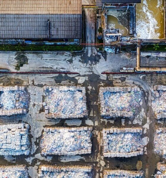 Aerial view of an industrial facility with piles of processed waste, highlighting waste management and CBG production.