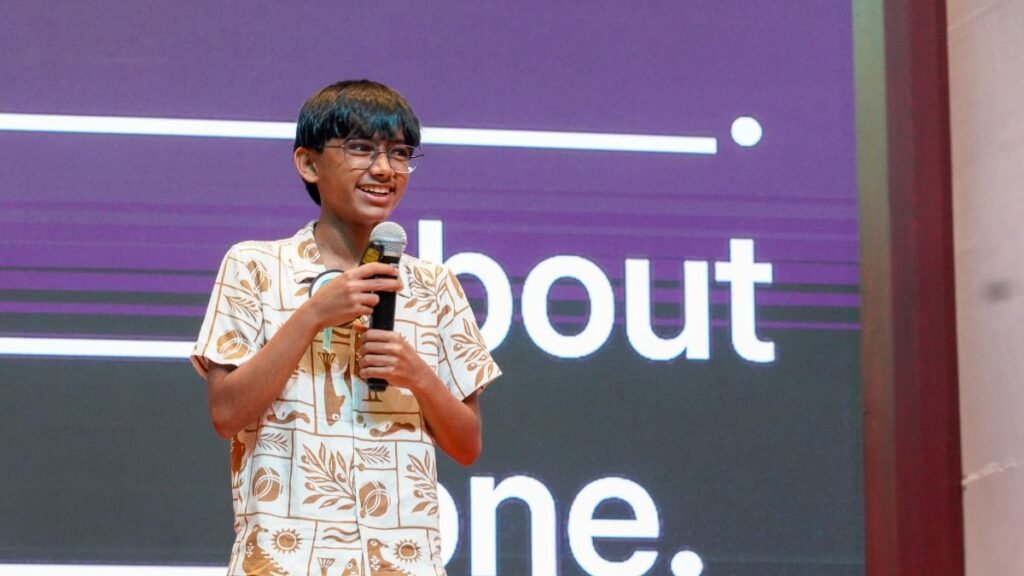 From a 12-Year-Old’s Robot to AI for India: Raul Aju John’s Journey 42 Raul Aju John speaking into a microphone at a technology event