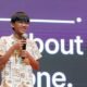 Raul Aju John speaking into a microphone at a technology event
