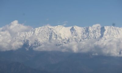 western himalaya warming. Snow-covered Himalayan peaks under a partly cloudy sky