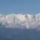 western himalaya warming. Snow-covered Himalayan peaks under a partly cloudy sky