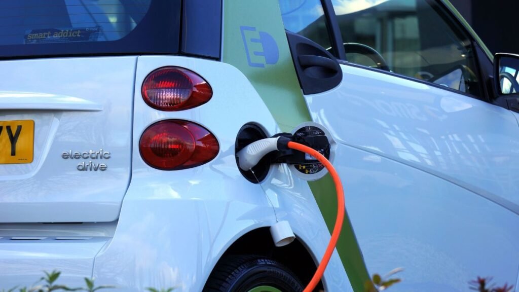 CNG, Hybrids and EVs Overtake Petrol in India’s Passenger Vehicle Market 42 Electric car charging with a plug, highlighting the growing EV market in India