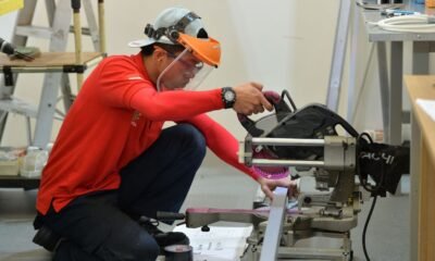 Skilled worker operating industrial machinery during technical training