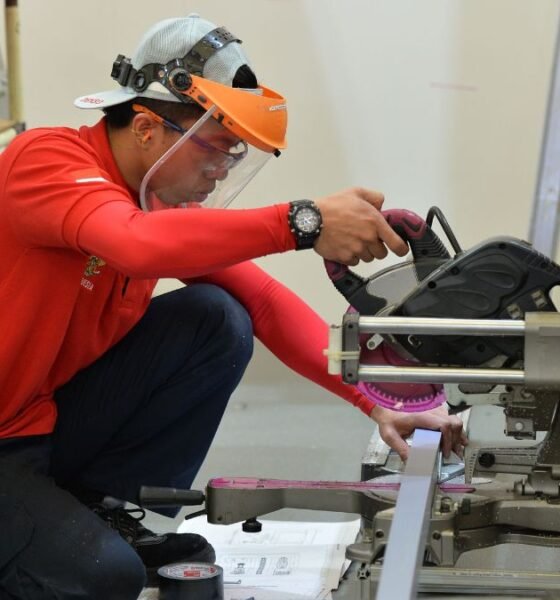 Skilled worker operating industrial machinery during technical training