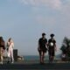 People walking and sitting in a European coastal city as rising temperatures increase heat exposure and heat-related health risks across Europe.