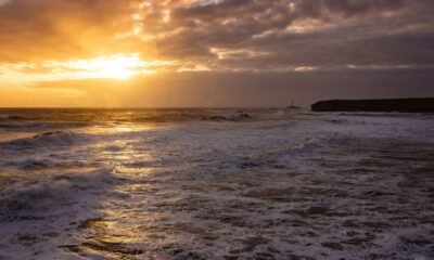 Ocean waves under a dramatic sunset as global ocean temperatures reach record highs