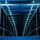 Rows of computer servers inside a large, illuminated data centre