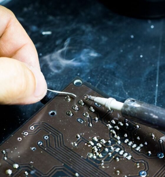Technician soldering a printed circuit board, illustrating hands-on electronics manufacturing and semiconductor industry skills