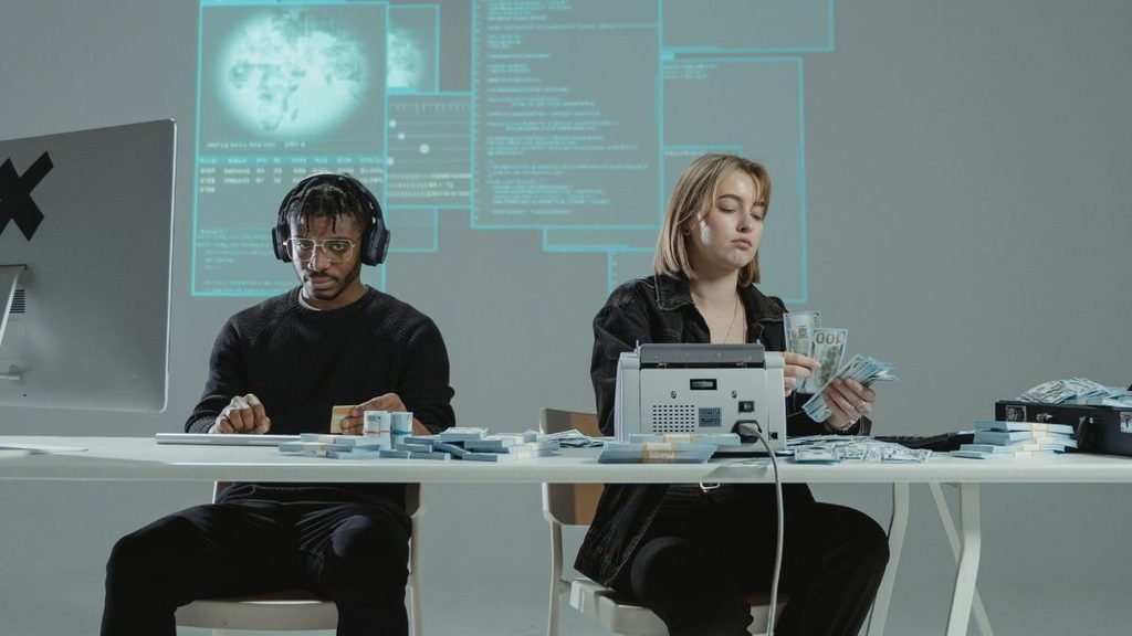 AGI: Two people count stacks of cash at a table with digital code and data displayed in the background.