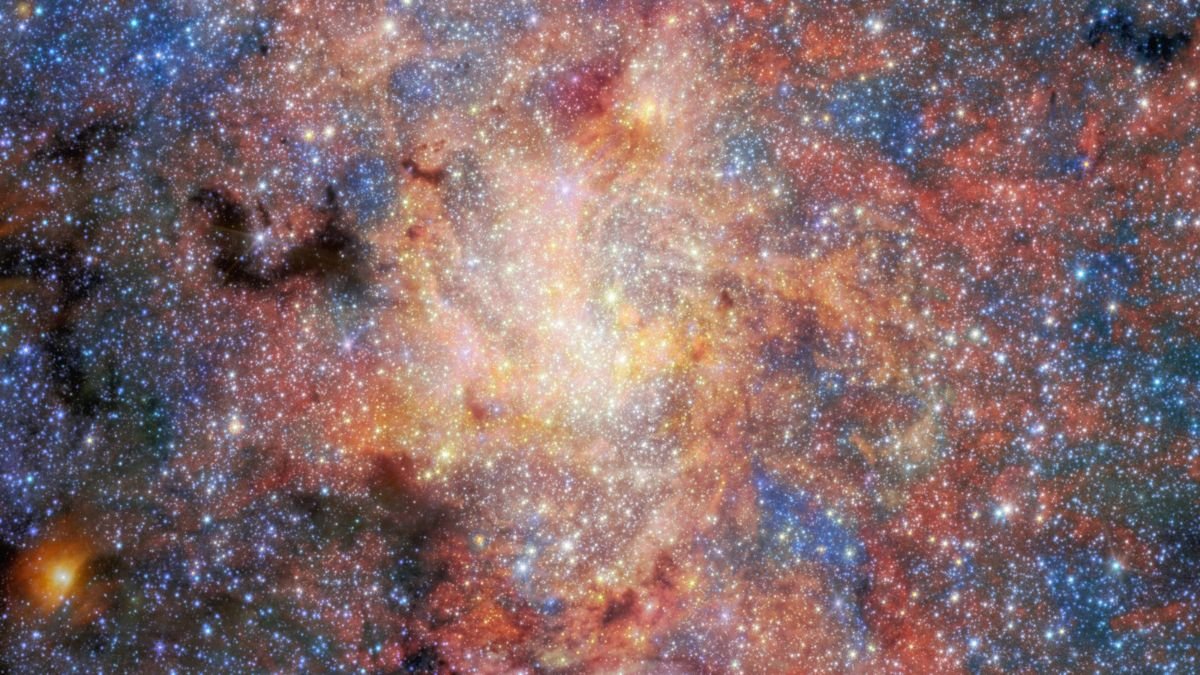 JWST infrared view of the densely populated region around the Milky Way’s central black hole, filled with stars, glowing gas and dust.