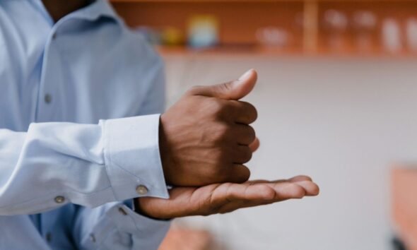 Hands demonstrating Indian Sign Language, highlighting visual communication for deaf people.