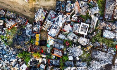 Aerial view of a scrap yard filled with discarded metal, wires and machinery parts, illustrating the scale of India’s growing waste management challenge