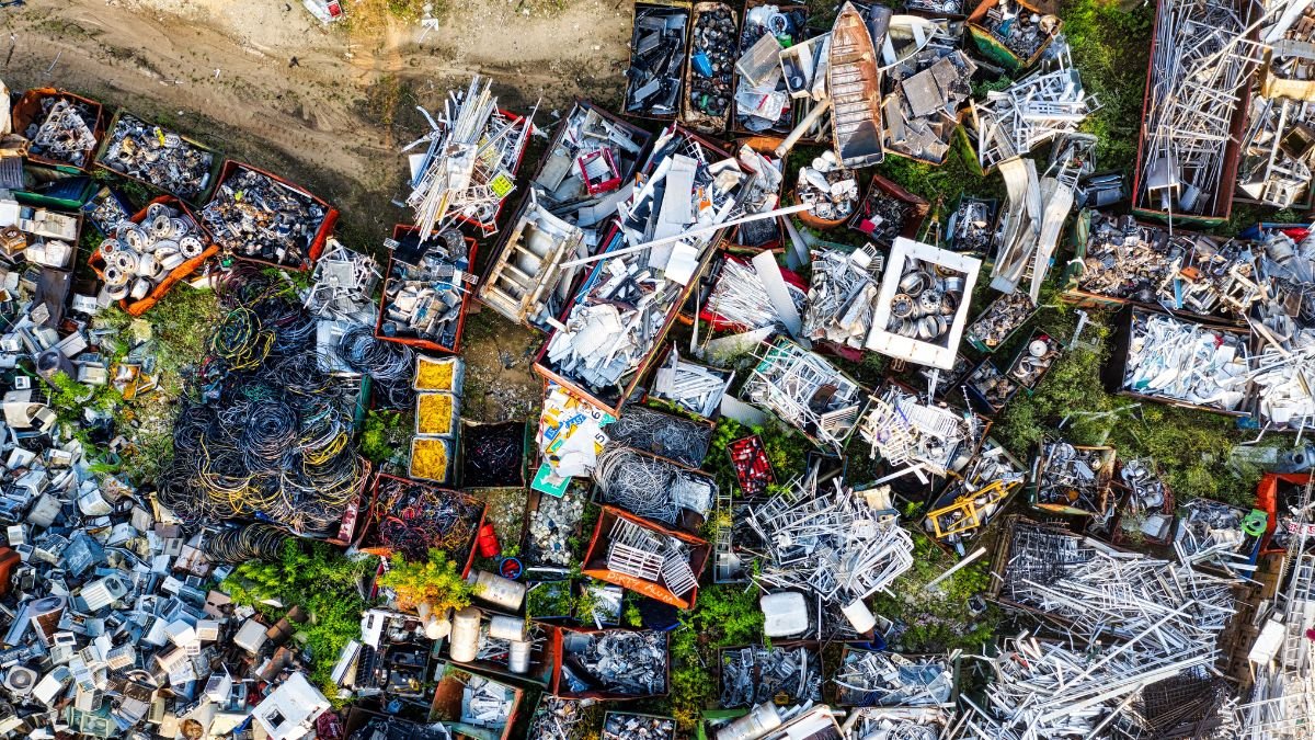 Aerial view of a scrap yard filled with discarded metal, wires and machinery parts, illustrating the scale of India’s growing waste management challenge