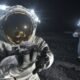 Astronaut holding a lunar rock on the Moon with another astronaut in the background, illustrating future lunar exploration.